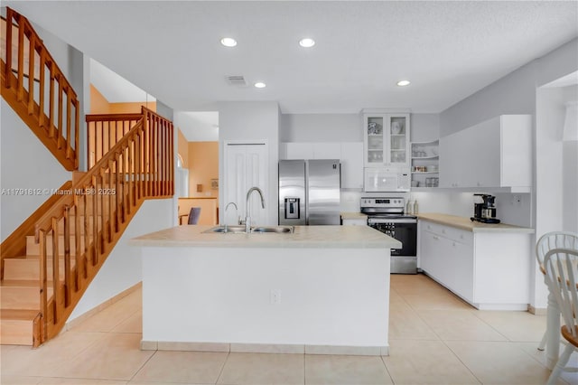 1060 NW 192nd Ave, Pembroke Pines, FL 33029 - kitchen with stainless steel appliances, open shelves, white cabinetry, recessed lighting, and an island with sink