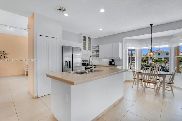 1060 NW 192nd Ave, Pembroke Pines, FL 33029 - kitchen featuring stainless steel fridge, white microwave, white cabinets, decorative light fixtures, and open shelves