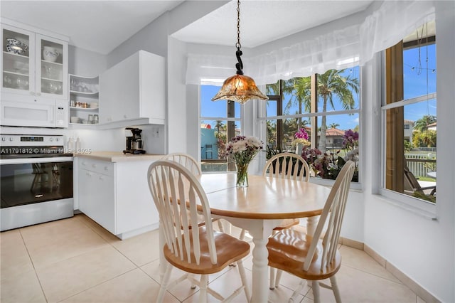 1060 NW 192nd Ave, Pembroke Pines, FL 33029 - dining space with light tile patterned floors and baseboards