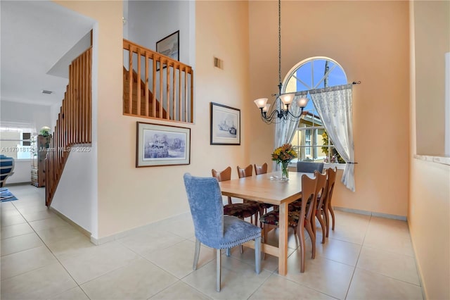 1060 NW 192nd Ave, Pembroke Pines, FL 33029 - dining space with stairway, plenty of natural light, a chandelier, light tile patterned floors, and a towering ceiling