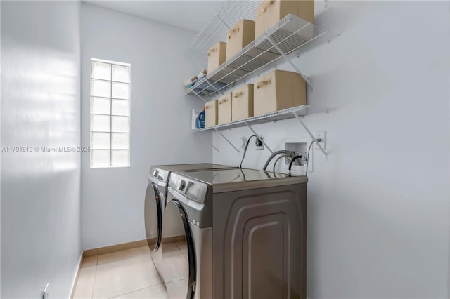 1060 NW 192nd Ave, Pembroke Pines, FL 33029 - laundry room with washer and dryer, baseboards, and light tile patterned floors