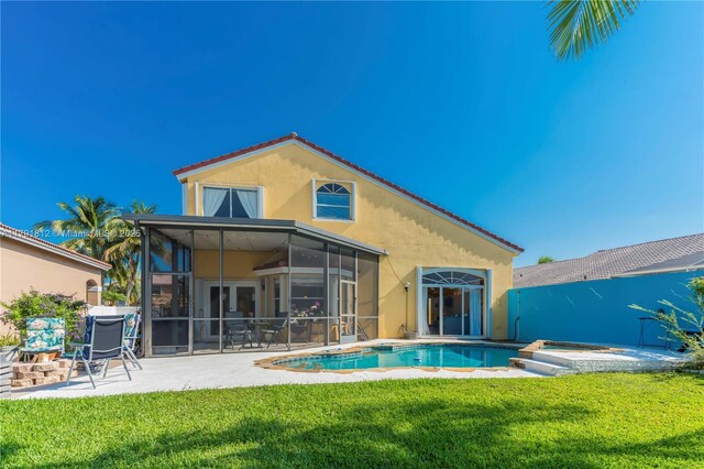 1060 NW 192nd Ave, Pembroke Pines, FL 33029 - back of property featuring a sunroom, a patio, stucco siding, and a lawn