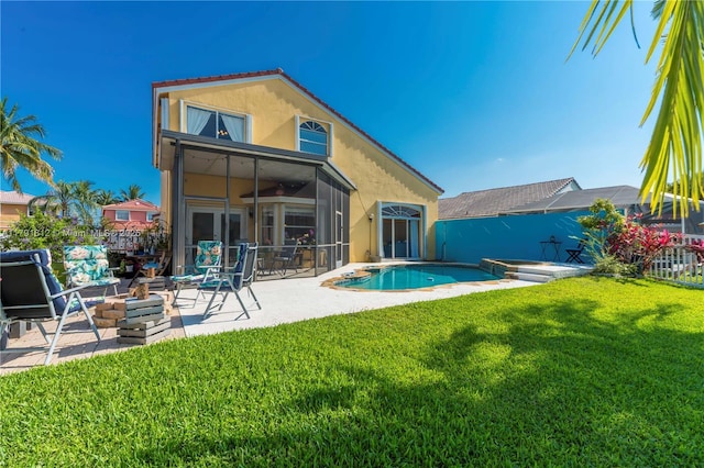 1060 NW 192nd Ave, Pembroke Pines, FL 33029 - back of house with a patio, stucco siding, a yard, and a sunroom