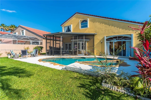 1060 NW 192nd Ave, Pembroke Pines, FL 33029 - back of house featuring a sunroom, stucco siding, a lawn, and a patio area