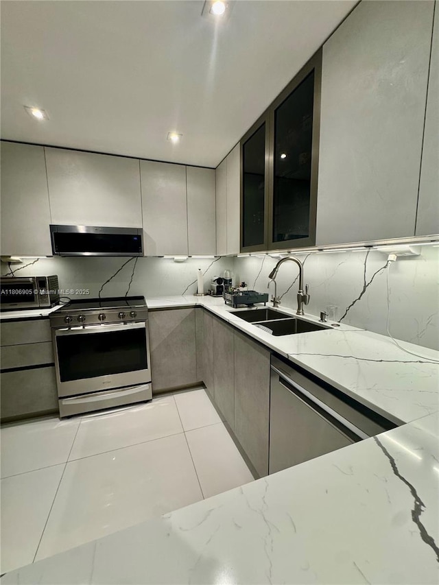 9801 Collins Ave Unit 19J, Bal Harbour, FL 33154 - kitchen featuring appliances with stainless steel finishes, exhaust hood, a sink, modern cabinets, and recessed lighting