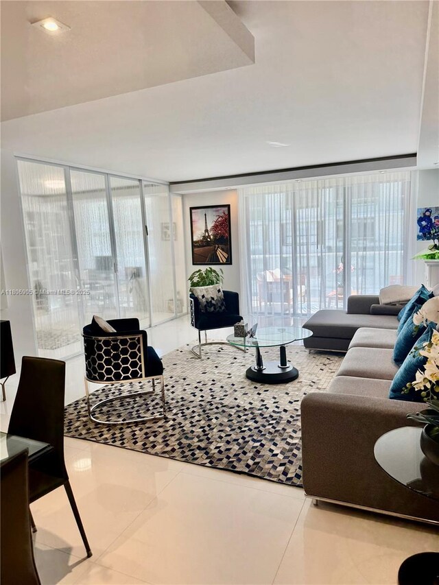 9801 Collins Ave Unit 19J, Bal Harbour, FL 33154 - living room with tile patterned flooring and a wall of windows