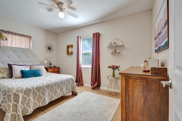 1222 14th Ct S, Lake Worth, FL 33460 - bedroom with multiple windows, light wood finished floors, ceiling fan, and baseboards