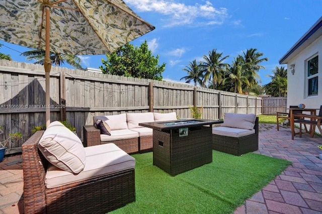 1222 S 14th Ct S, Lake Worth, FL 33460 - fenced backyard with an outdoor living space with a fire pit and a patio area