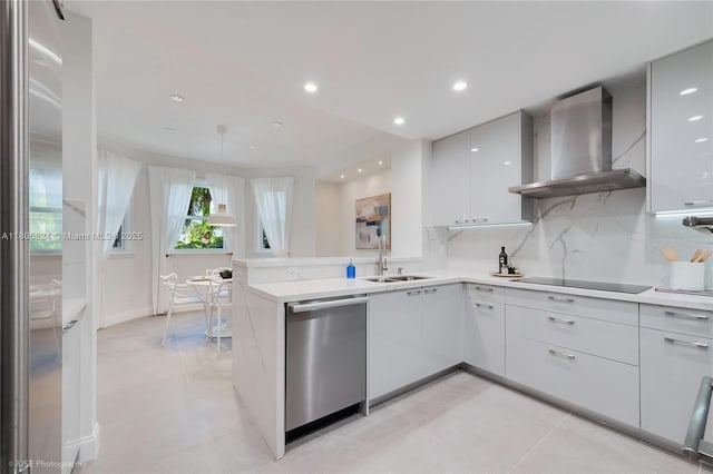 13637 Deering Bay Dr Unit 231, Coral Gables, FL 33158 - kitchen with appliances with stainless steel finishes, wall chimney range hood, a sink, modern cabinets, and light countertops
