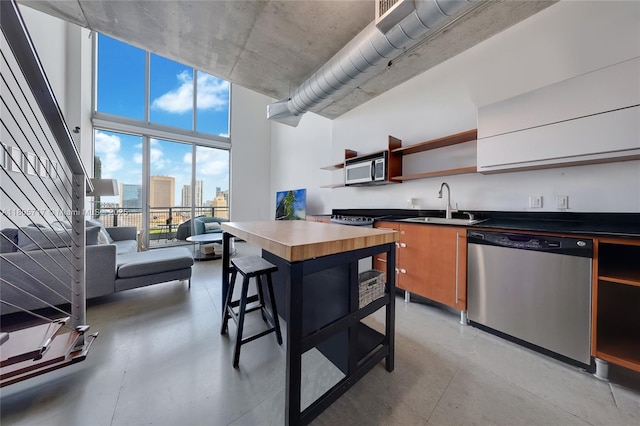 690 SW 1st Ct Unit 2109, Miami, FL 33130 - kitchen with stainless steel dishwasher, open shelves, a sink, dark countertops, and a city view