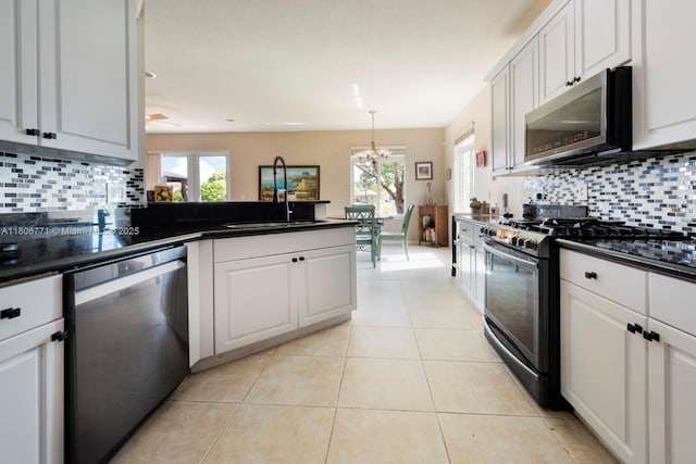 19311 SW 61st St, Pembroke Pines, FL 33332 - kitchen featuring stainless steel appliances, dark countertops, backsplash, and light tile patterned floors