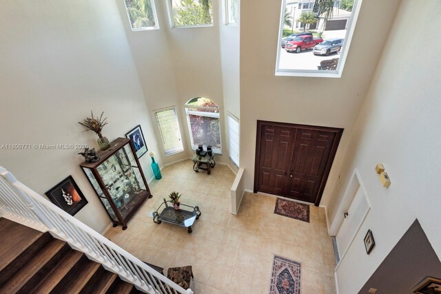 19311 SW 61st St, Pembroke Pines, FL 33332 - foyer featuring a high ceiling, tile patterned flooring, stairway, and baseboards