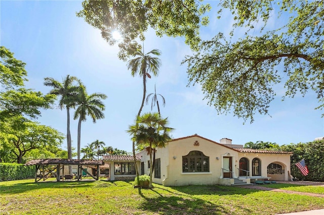 1510 Madrid St, Coral Gables, FL 33134 - back of house featuring stucco siding, a lawn, and a tile roof