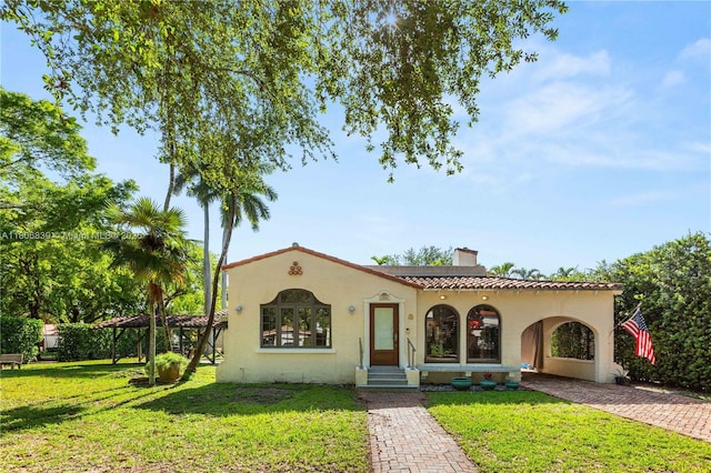 1510 Madrid St, Coral Gables, FL 33134 - mediterranean / spanish house with a chimney, a front lawn, and stucco siding
