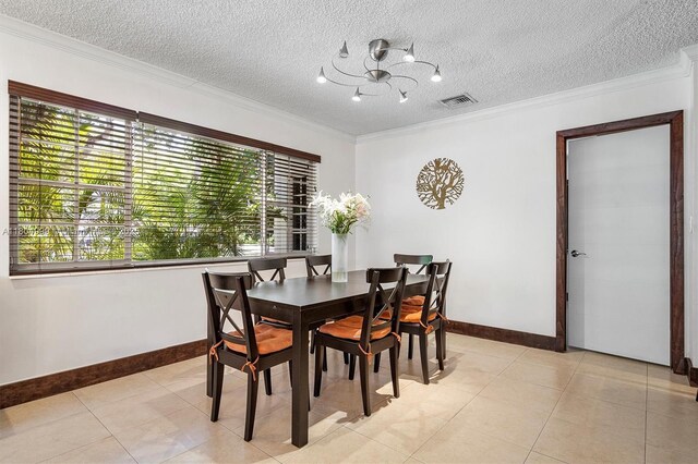 1693 NE 171st St, North Miami Beach, FL 33162 - dining area with baseboards, crown molding, a chandelier, a textured ceiling, and light tile patterned floors