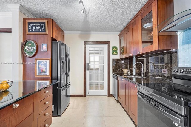 1693 NE 171st St, North Miami Beach, FL 33162 - kitchen featuring stainless steel appliances, a sink, crown molding, decorative backsplash, and glass insert cabinets