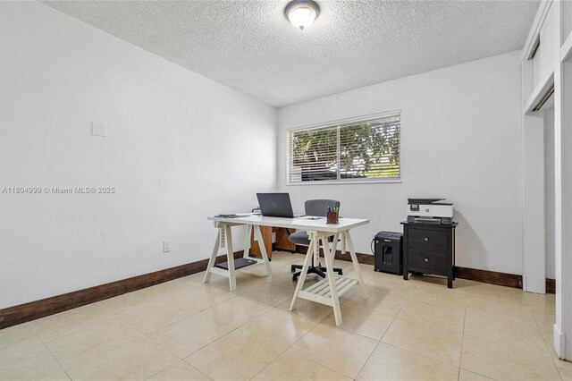 1693 NE 171st St, North Miami Beach, FL 33162 - office area featuring a textured ceiling, baseboards, and light tile patterned floors