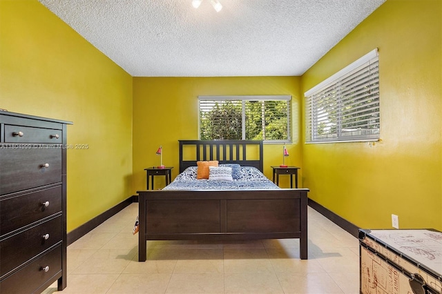 1693 NE 171st St, North Miami Beach, FL 33162 - bedroom featuring a textured ceiling, baseboards, and light tile patterned floors