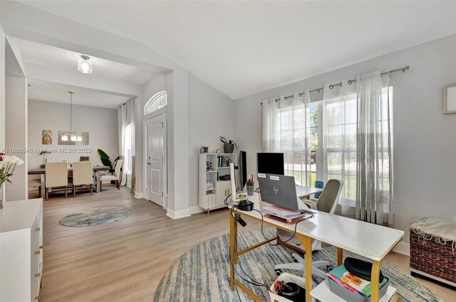 2316 SW Santana Ave, Port St Lucie, FL 34953 - home office with light wood-style flooring, a chandelier, vaulted ceiling, and baseboards