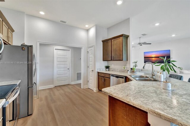 2316 SW Santana Ave, Port St Lucie, FL 34953 - kitchen featuring a sink, stainless steel appliances, a ceiling fan, light wood finished floors, and light countertops