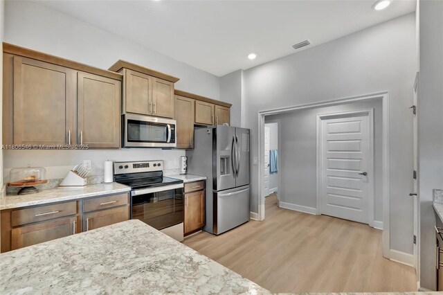 2316 SW Santana Ave, Port St Lucie, FL 34953 - kitchen with stainless steel appliances, light wood-type flooring, baseboards, and recessed lighting