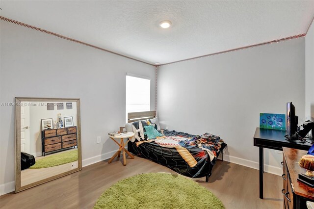 2316 SW Santana Ave, Port St Lucie, FL 34953 - bedroom with baseboards and wood finished floors