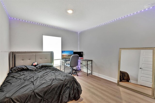 2316 SW Santana Ave, Port St Lucie, FL 34953 - bedroom with wood finished floors, baseboards, and a desk