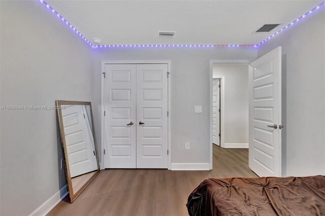 2316 SW Santana Ave, Port St Lucie, FL 34953 - bedroom featuring wood finished floors, a closet, and baseboards