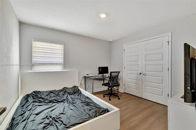 2316 SW Santana Ave, Port St Lucie, FL 34953 - bedroom with light wood-type flooring, a closet, and an office area