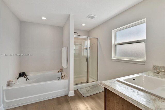 2316 SW Santana Ave, Port St Lucie, FL 34953 - full bathroom featuring wood finished floors, a shower stall, a bath, and vanity