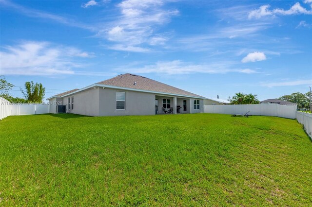 2316 SW Santana Ave, Port St Lucie, FL 34953 - back of house with stucco siding and cooling unit