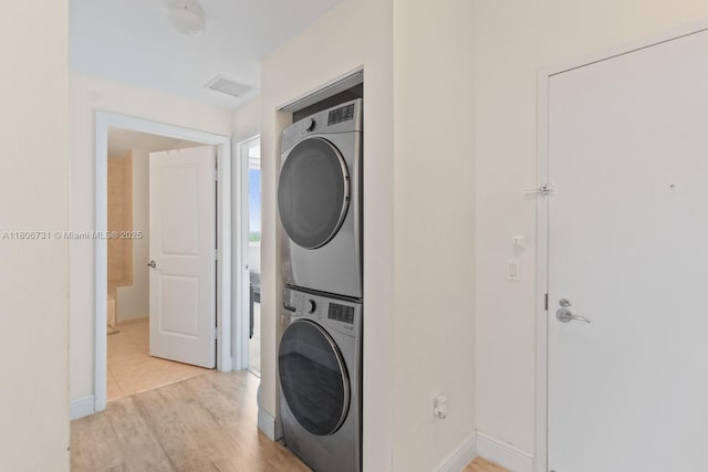 2641 N Flamingo Rd Unit 2408N, Sunrise, FL 33323 - laundry area with stacked washer / dryer, light wood-style floors, and baseboards