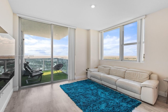 2641 N Flamingo Rd Unit 2408N, Sunrise, FL 33323 - living room with plenty of natural light, wood finished floors, baseboards, and floor to ceiling windows