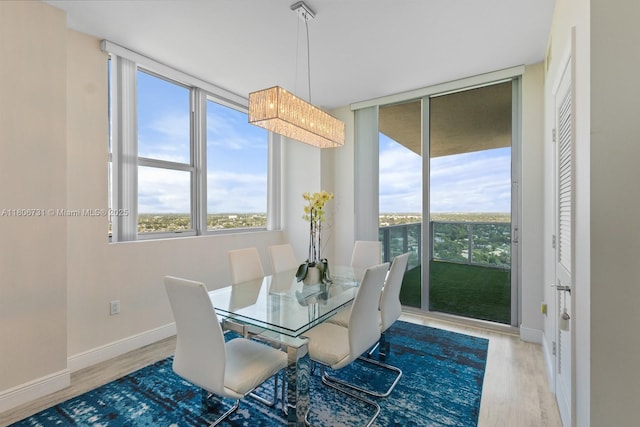 2641 N Flamingo Rd Unit 2408N, Sunrise, FL 33323 - dining room featuring healthy amount of natural light, wood finished floors, and baseboards