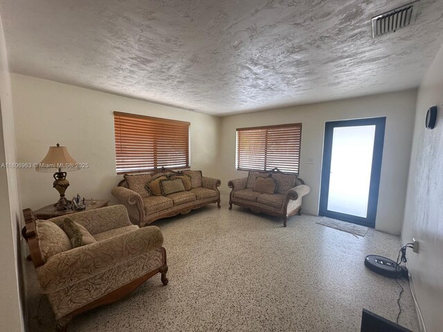 732 Burlington St, Opa-Locka, FL 33054 - living area with speckle patterned floor and a textured ceiling