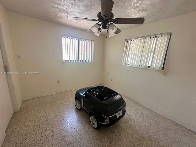 732 Burlington St, Opa-Locka, FL 33054 - spare room featuring speckle patterned floor, a ceiling fan, and baseboards