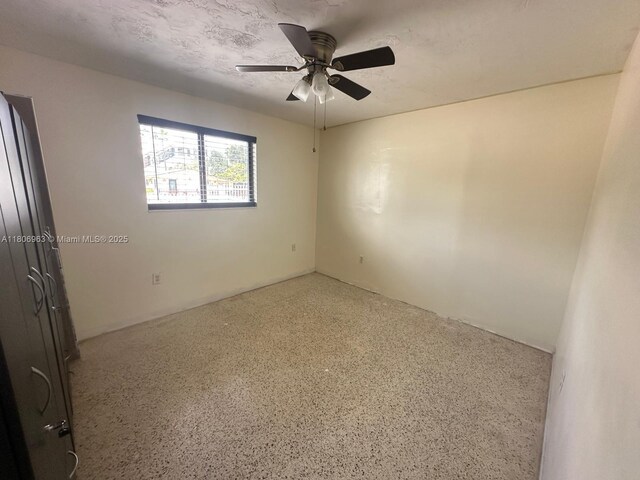 732 Burlington St, Opa-Locka, FL 33054 - empty room featuring ceiling fan and speckle patterned floor