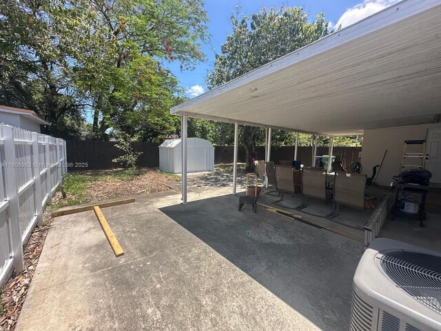 732 Burlington St, Opa-Locka, FL 33054 - view of vehicle parking featuring a fenced backyard and a storage shed