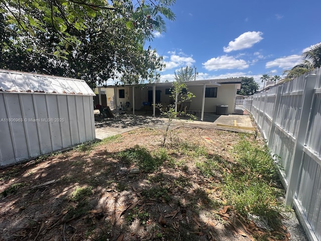 732 Burlington St, Opa-Locka, FL 33054 - back of property with a patio area, a fenced backyard, central AC, and stucco siding