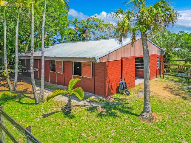 22800 SW 157th Ave, Miami, FL 33170 - view of side of property featuring metal roof, an exterior structure, a garage, and an outdoor structure