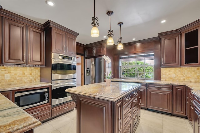 9620 E Calusa Club Dr, Miami, FL 33186 - kitchen with appliances with stainless steel finishes, light stone countertops, backsplash, pendant lighting, and recessed lighting