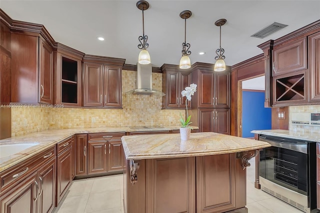 9620 E Calusa Club Dr, Miami, FL 33186 - kitchen with beverage cooler, wall chimney exhaust hood, light tile patterned flooring, backsplash, and light stone counters