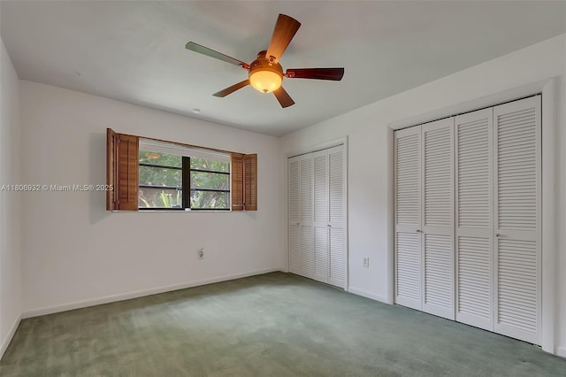 9620 E Calusa Club Dr, Miami, FL 33186 - unfurnished bedroom featuring two closets, carpet floors, baseboards, and a ceiling fan