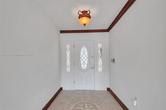 9620 E Calusa Club Dr, Miami, FL 33186 - foyer entrance featuring baseboards, ornamental molding, and light tile patterned floors