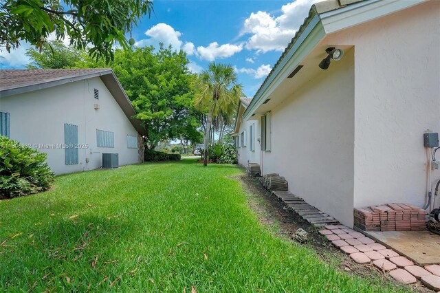 9620 E Calusa Club Dr, Miami, FL 33186 - view of grassy yard featuring central AC