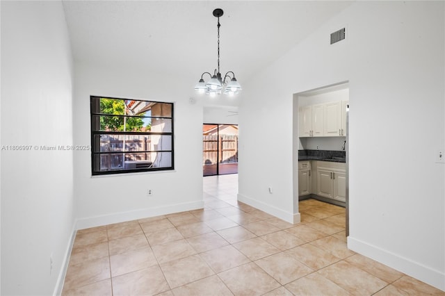 4609 SW 143rd Pl, Miami, FL 33175 - empty room with a chandelier, a sink, light tile patterned floors, baseboards, and high vaulted ceiling