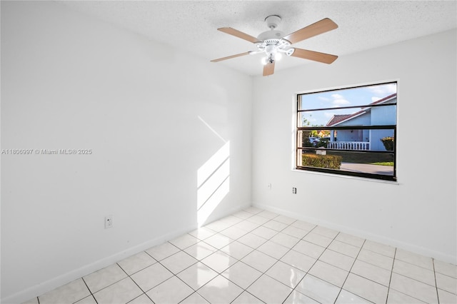 4609 SW 143rd Pl, Miami, FL 33175 - spare room featuring a textured ceiling, baseboards, a ceiling fan, and light tile patterned floors