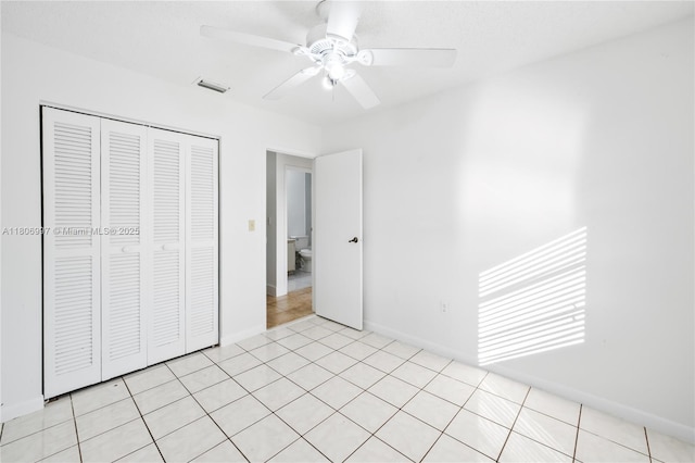 4609 SW 143rd Pl, Miami, FL 33175 - unfurnished bedroom featuring a closet, baseboards, a ceiling fan, and light tile patterned floors