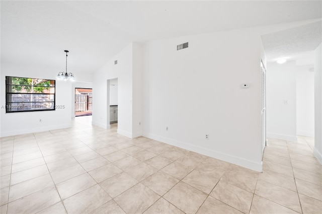 4609 SW 143rd Pl, Miami, FL 33175 - empty room featuring light tile patterned floors, lofted ceiling, a chandelier, and baseboards