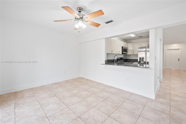 4609 SW 143rd Pl, Miami, FL 33175 - kitchen with stainless steel appliances, a ceiling fan, and baseboards